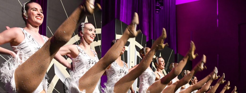 Kickline of Rockettes style performers women kick dance